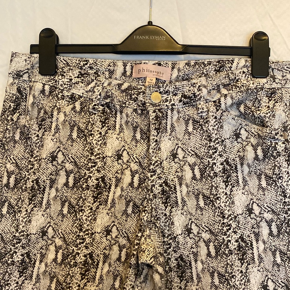Snake print skinny leg mid rise pants with stretch.